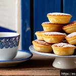 Home 19 포르투갈 여행 중 쇼핑할 만한 아이템 - A close-up, high-resolution image of traditional Portuguese pastéis de nata arranged on a rustic woo...
